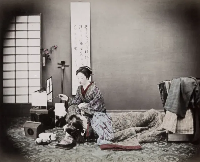 Framed Print : c. 1880s Japan - two geishas, studio scene, shamisen and tea set Framed Print : c. 1880s Japan - two geishas, studio scene, shamisen and tea set