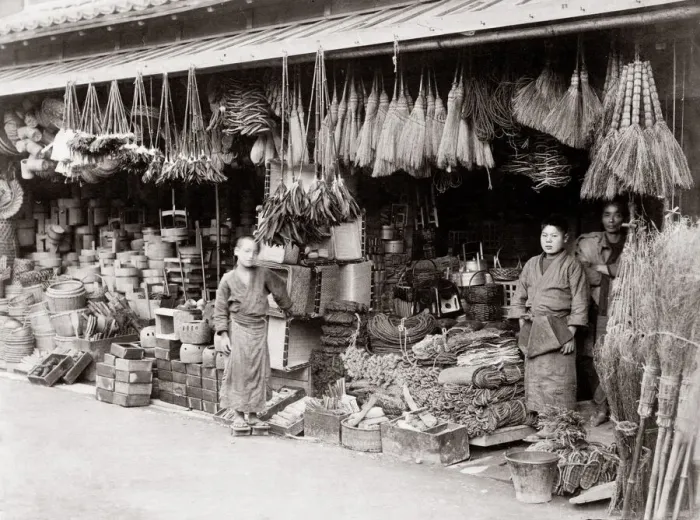 Framed Print : c. 1880s Japan - shop selling brroms, baskets, rope Framed Print : c. 1880s Japan - shop selling brroms, baskets, rope