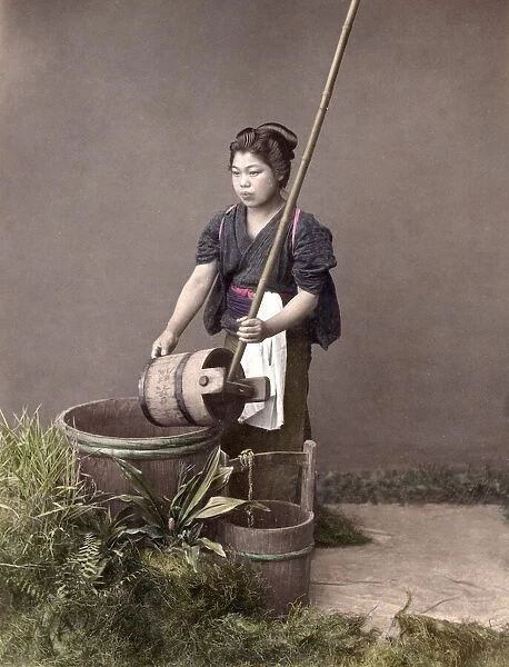 c. 1880s Japan - young woman filling a bucket