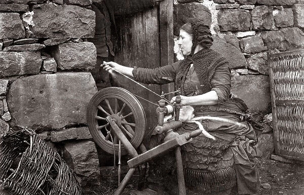 c. 1880s Scotland - woman spinning wool on a spinning wheel