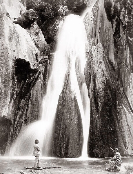 c. 1890s India - two European men in front of a waterfall