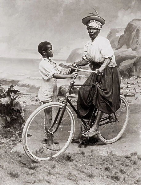 c. 1900 West Indies - old woman on bicycle with a child