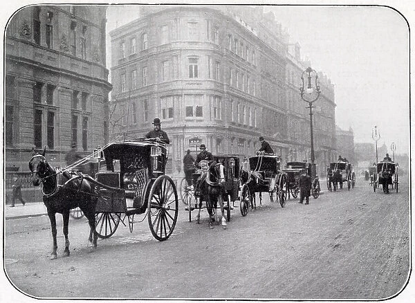 A cab rank in central London - a mixture of hansoms (two- wheelers) and victorias (four- wheelers). Date: 1902