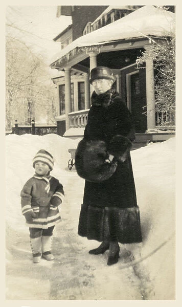 Canada - Grandmother and young grandchild outside her home