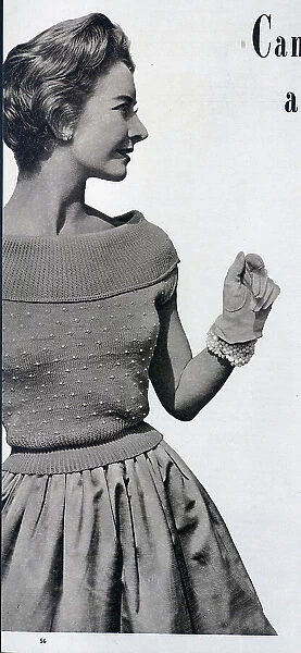 A canoe-necked knitted top, with a beaded design. Date: 1954