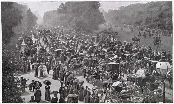 Carriages driving along the south side of Hyde Park, central London. Date: 1900