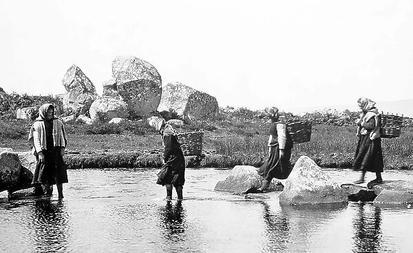 Carrying turf in creels, West of Ireland, early 1900s
