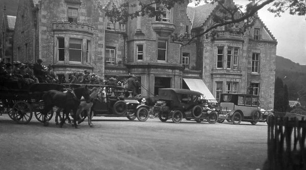 Cars and a carriage at the Tarbet Hotel, Scotland
