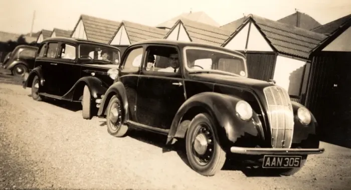 Framed Print : Cars parked by a row of garages Framed Print : Cars parked by a row of garages