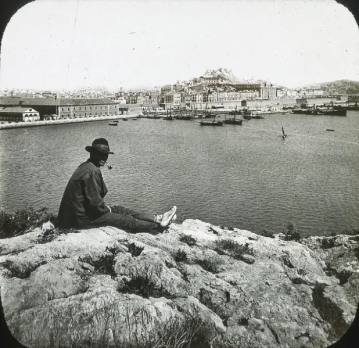 Framed Print : Cartagena - Black and white- man sitting on rock in foreground overlooking harbour Date Framed Print : Cartagena - Black and white- man sitting on rock in foreground overlooking harbour Date