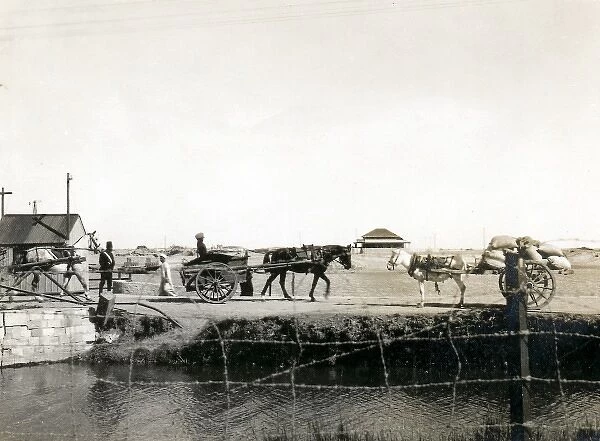 Carts meeting on a bridge, Middle East