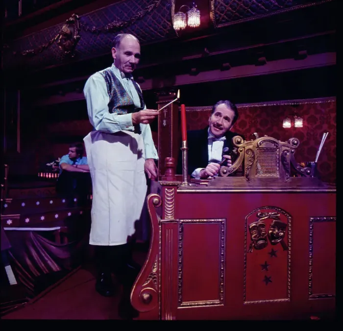 Framed Print : Two of the cast of the Old Time Music Hall TV show, known as The Good Old Days, filmed at the City Varieties in Leeds. The man on the left lights a candle, while the compere, played by the actor Leonard Sachs, smiles benignly. Date: 1960s Framed Print : Two of the cast of the Old Time Music Hall TV show, known as The Good Old Days, filmed at the City Varieties in Leeds. The man on the left lights a candle, while the compere, played by the actor Leonard Sachs, smiles benignly. Date: 1960s