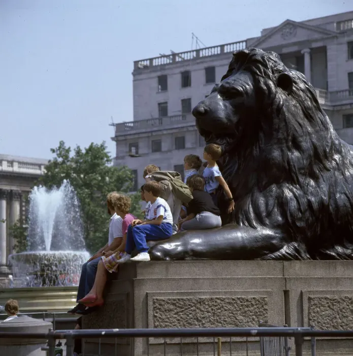 Framed Print : Children and adults sit on a Landseer Lion, Trafalgar Square Framed Print : Children and adults sit on a Landseer Lion, Trafalgar Square