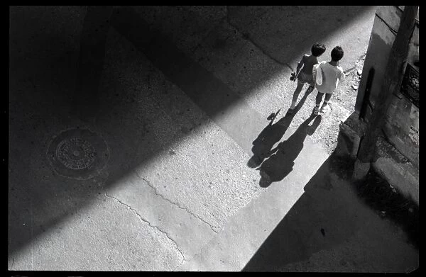 Children casting shadows, Valencia, Spain