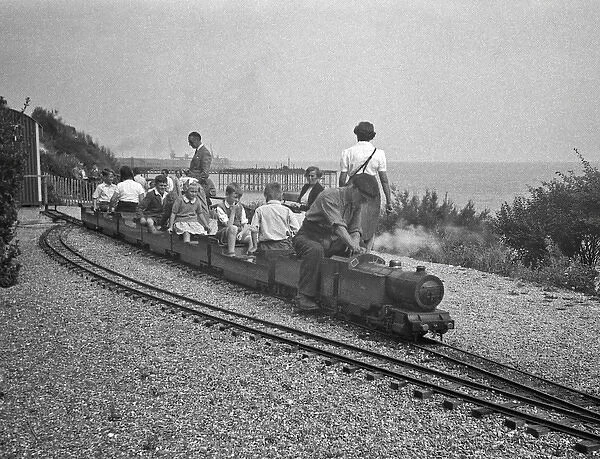 Children on miniature train at seaside