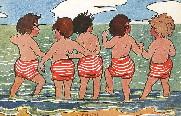 Children paddling and looking out to sea