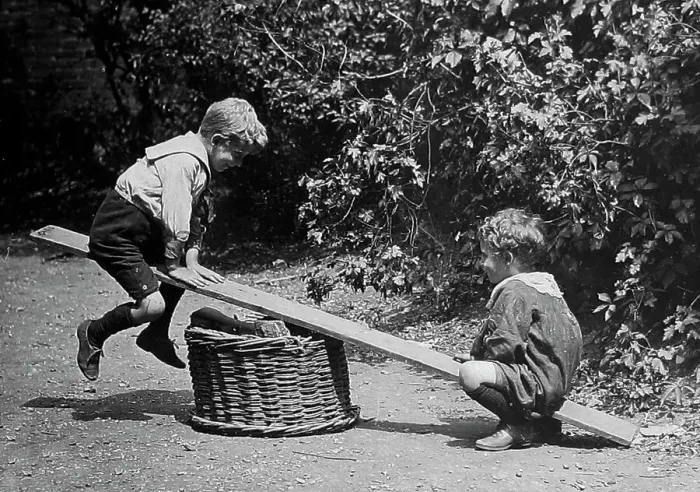 Framed Print : Children playing on a see-saw early 1900s Framed Print : Children playing on a see-saw early 1900s