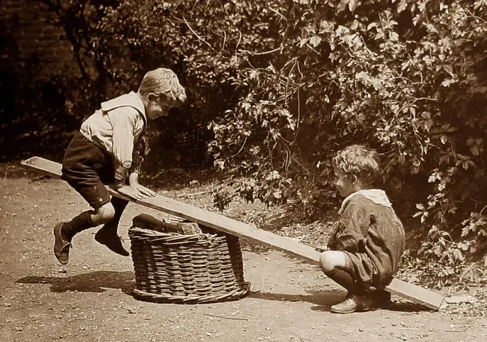 Framed Print : Children playing on a seesaw Framed Print : Children playing on a seesaw