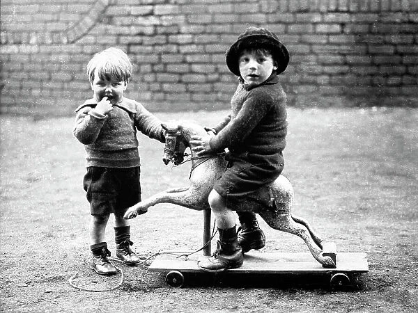 Children playing on wooden horse