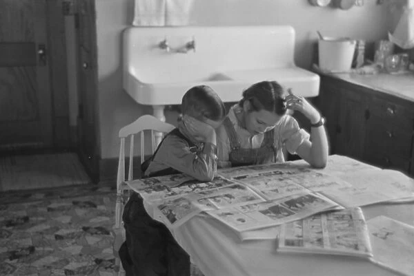 Children reading Sunday papers, Rustan brothers farm near D