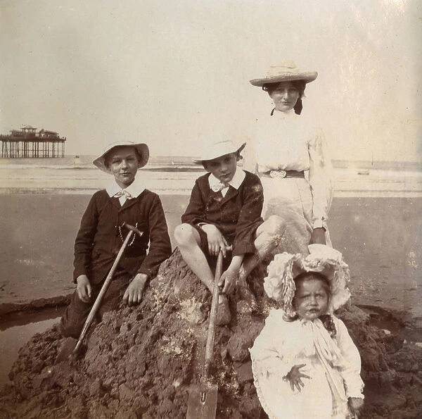 Four children on a sandcastle, Saltburn, North Yorkshire