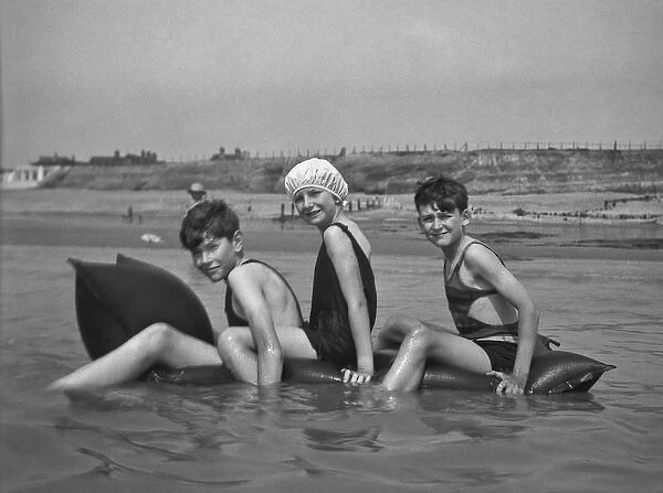 Three children at the seaside