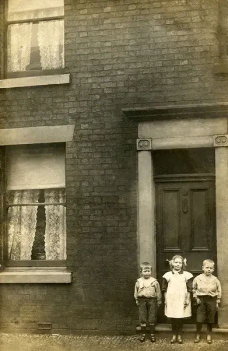 Framed Print : Three children stand outside their front door Framed Print : Three children stand outside their front door