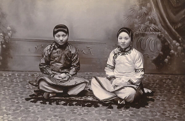 Two Chinese Girls seated on a small rug