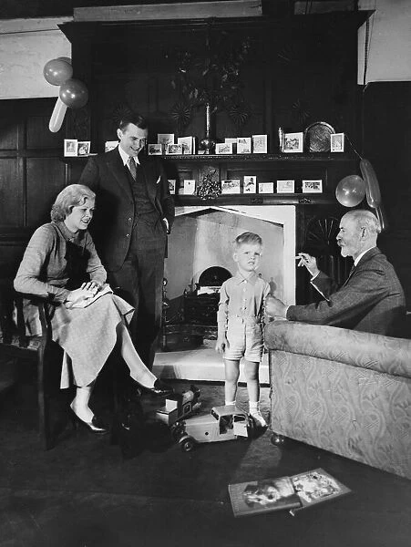 CHRISTMAS 1930S. A little boy is the centre of attention