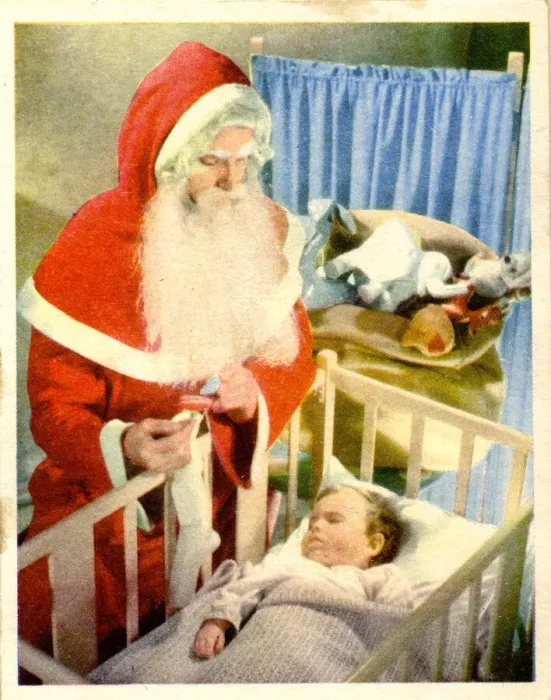 Framed Print : Christmas card, Santa Claus visiting baby in cot Framed Print : Christmas card, Santa Claus visiting baby in cot