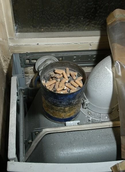 Cigarette butts in a tin