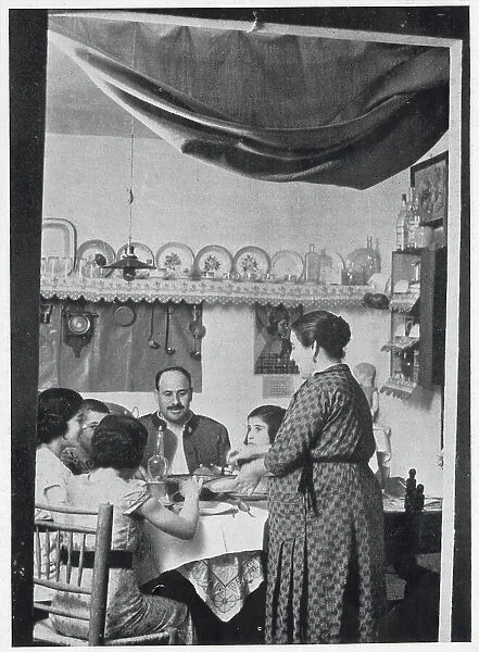 A Civil Guardsman having dinner with his family in their private rooms at a Civil Guard Barracks, Spain, 1936. The Civil Guard were a cross between a military unit and a police force