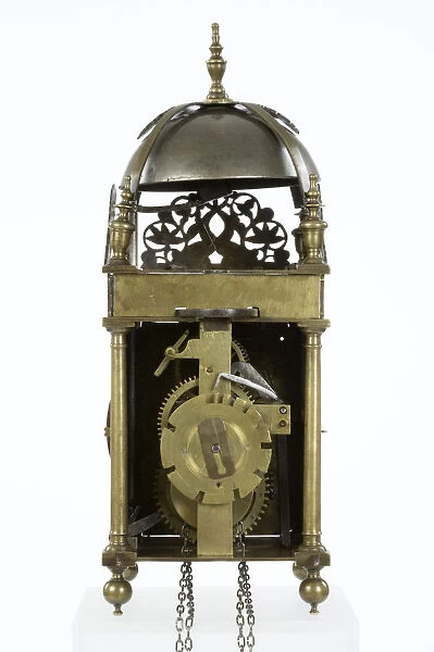 Clock, reverse. Brass and metal lantern clock on four ball feet