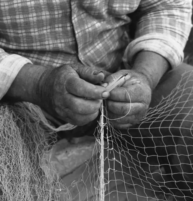 Framed Print : Close-up of fishermans hands, mending a net Framed Print : Close-up of fishermans hands, mending a net