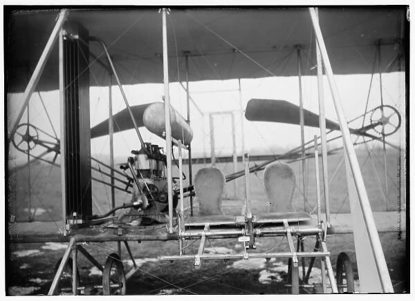 Close-up view of airplane, including the pilot and passenger