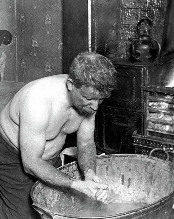 Framed Print : Coal miner washing at home