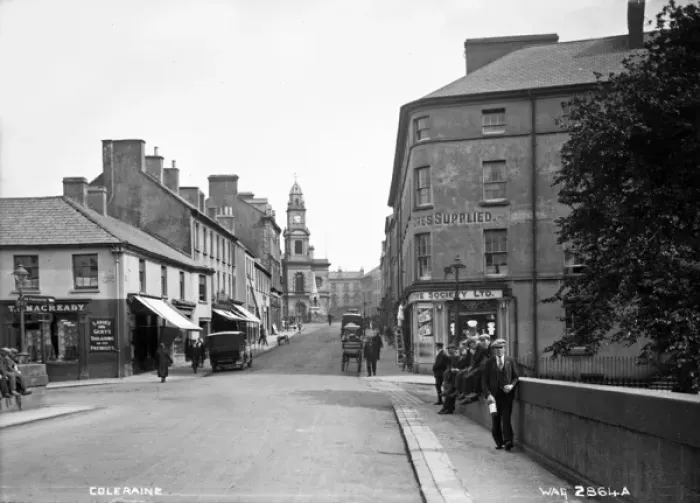 Framed Print : Coleraine - a street scene with shop fronts, motor cars and people, taken Framed Print : Coleraine - a street scene with shop fronts, motor cars and people, taken