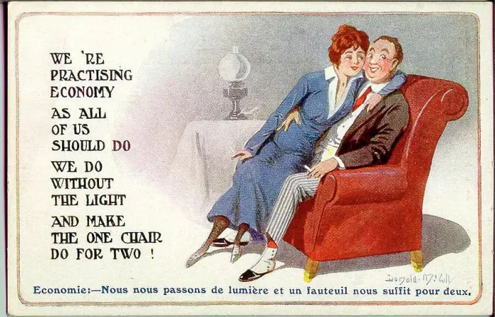 Framed Print : Comic postcard, Young couple in an armchair with the light out - making the best of wartime restrictions. Date: 1914-1918 Framed Print : Comic postcard, Young couple in an armchair with the light out - making the best of wartime restrictions. Date: 1914-1918