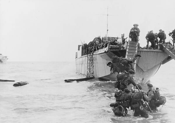Commandos wade ashore from landing craft at Juno beach