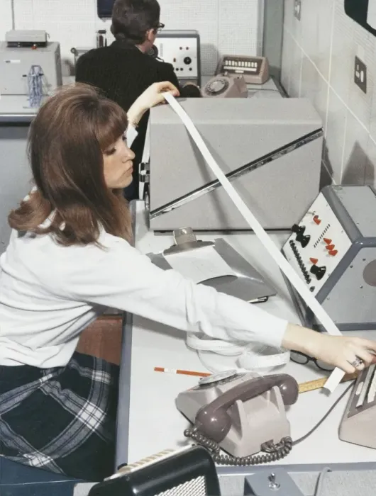 Framed Print : A computer technician with data tape Framed Print : A computer technician with data tape