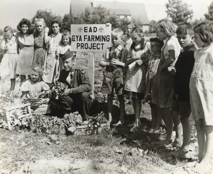 Framed Print : A Corporal with German Children Growing Vegetables at th? Framed Print : A Corporal with German Children Growing Vegetables at th?