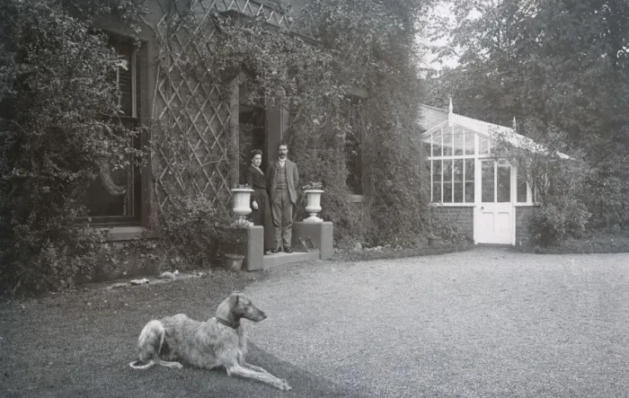 Framed Print : Couple in doorway with a dog Framed Print : Couple in doorway with a dog