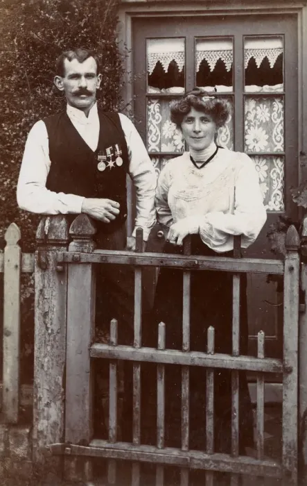 Framed Print : Couple at gate, man wearing Boer War medals Framed Print : Couple at gate, man wearing Boer War medals