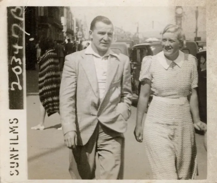 Framed Print : Couple strolling along the front on holiday in Weymouth Framed Print : Couple strolling along the front on holiday in Weymouth