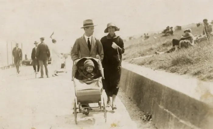 Framed Print : Couple strolling along the seafront with toddler in buggy Framed Print : Couple strolling along the seafront with toddler in buggy