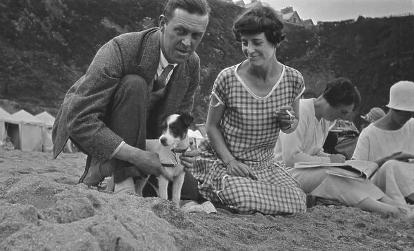 Couple with terrier puppy, Newquay, Cornwall