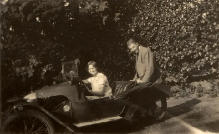 Framed Print : Couple in a tiny three-wheeled car Framed Print : Couple in a tiny three-wheeled car