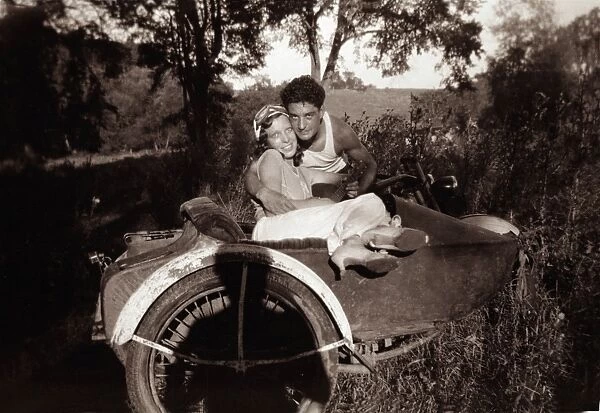 Couple together with1948 Harley Davidson motorcycle sidecar