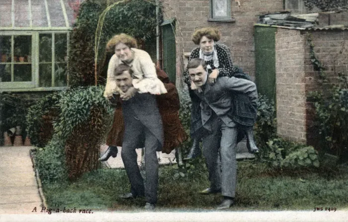 Framed Print : Two Couples have a piggy-back race in the back garden Framed Print : Two Couples have a piggy-back race in the back garden