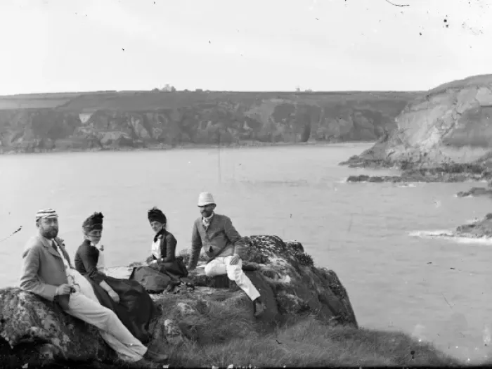 Framed Print : Two couples sitting on a cliff top